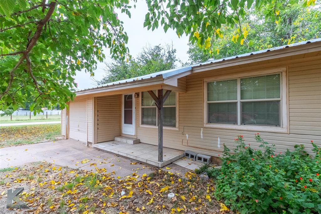 1004 North 9th Street Haskell, TX 79521 - Photo 1 of 1 View of front of house featuring a metal roof, a patio, and driveway