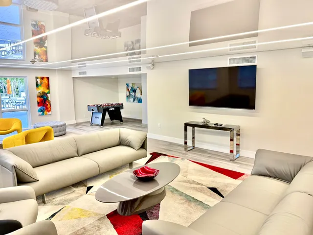 a room with a couch and a painting on the wall