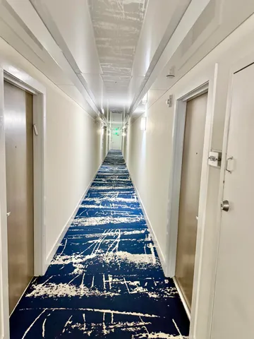 a living room with furniture and a book shelf