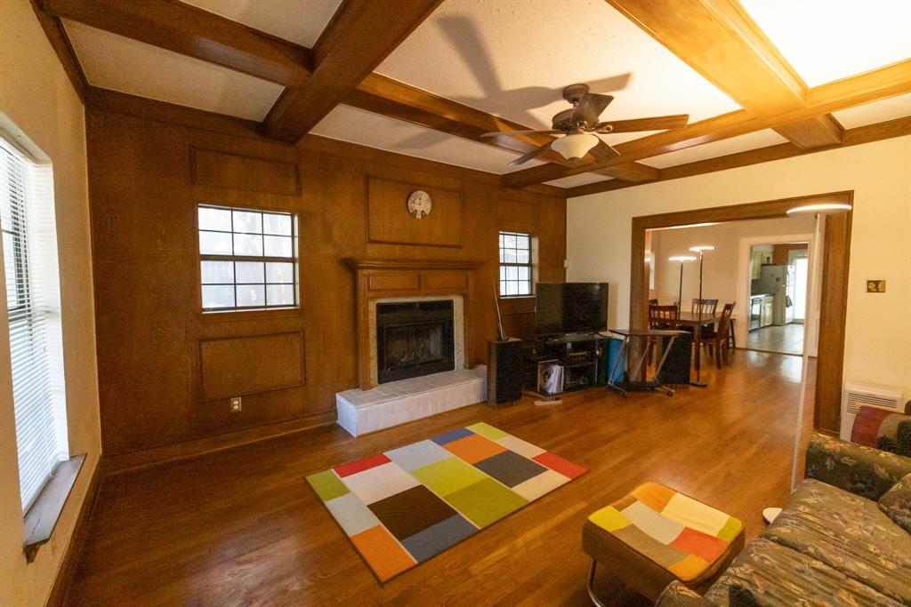 700 North Beacon Street Dallas, TX 75214 - Photo 5 of 13 a living room with furniture a dining table and a fireplace