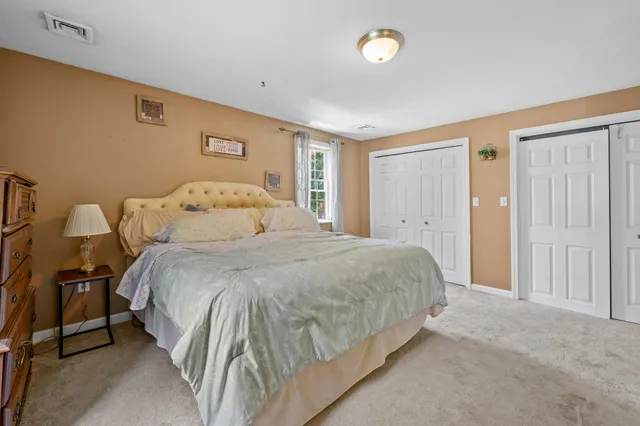 a large bed sitting in a bedroom and a table