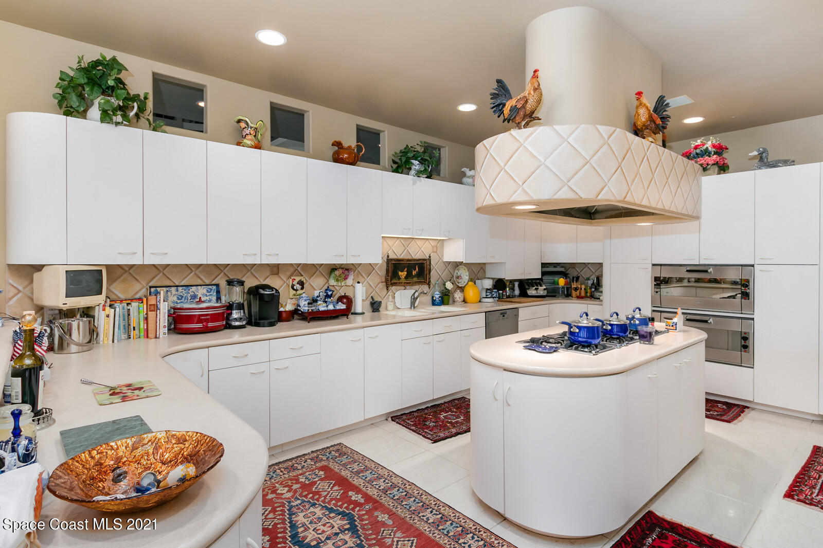 2021 Bali Road Cocoa Beach, FL 32931 - Photo 14 of 50 Curved Cabinetry and gas top burners