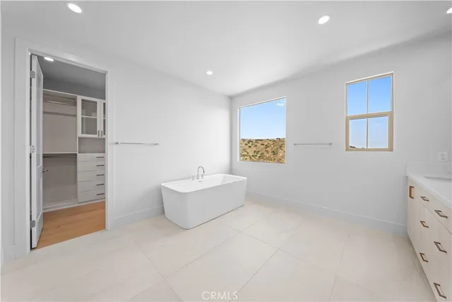 a spacious bathroom with a bathtub and shower