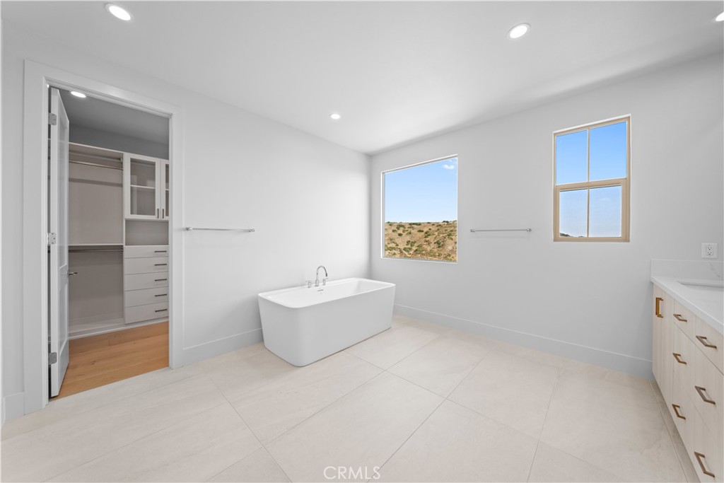 100 Mossvine Irvine, CA 92618 - Photo 23 of 44 a view of an empty room with a cabinet and mirror