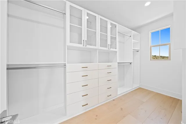 a spacious bathroom with a shower sink and mirror