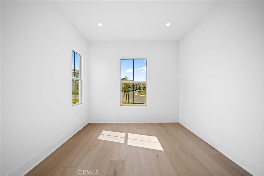 100 Mossvine Irvine, CA 92618 - Photo 6 of 44 an empty room with wooden floor and windows