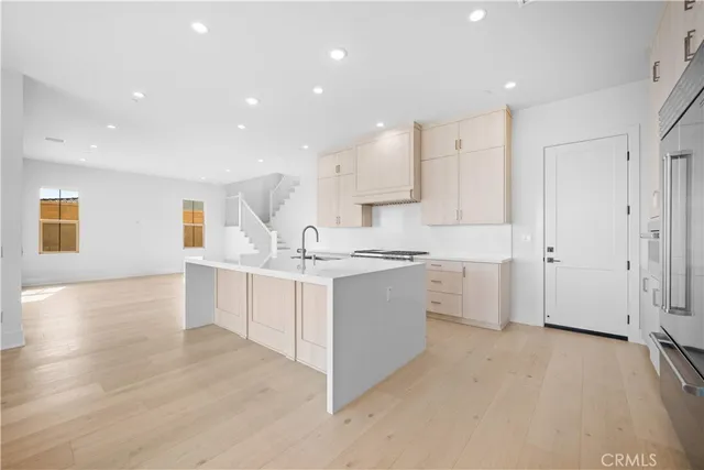 a large white kitchen with a large window