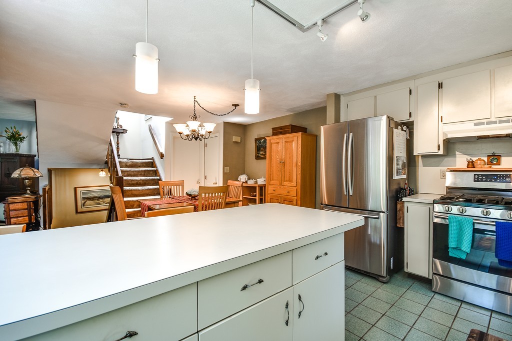 124 Mountain Gate Road, Unit 124 Ashland, MA 01721 - Photo 11 of 19 a kitchen with stainless steel appliances a sink and a refrigerator