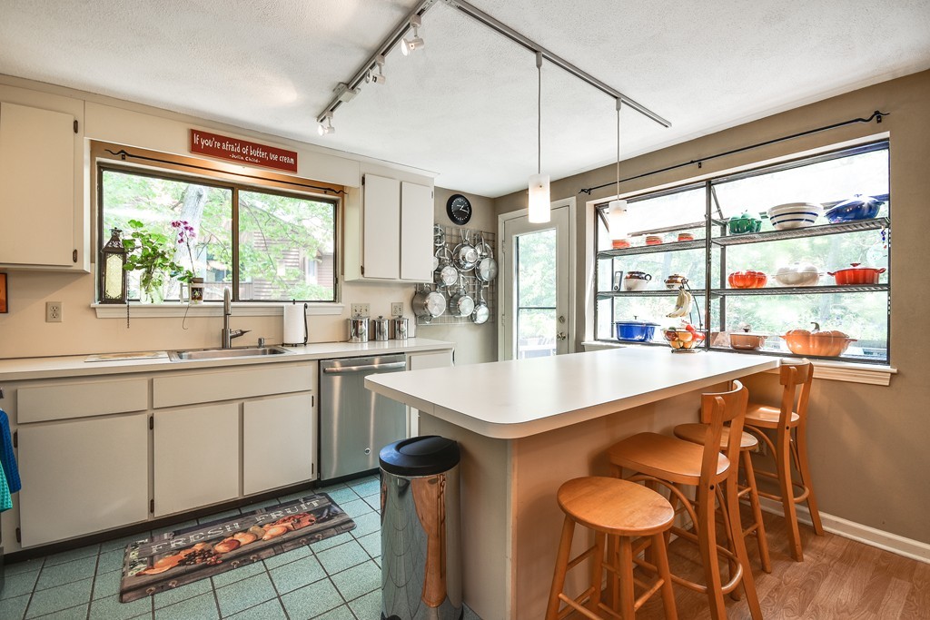 124 Mountain Gate Road, Unit 124 Ashland, MA 01721 - Photo 12 of 19 a kitchen with stainless steel appliances granite countertop a sink and a refrigerator