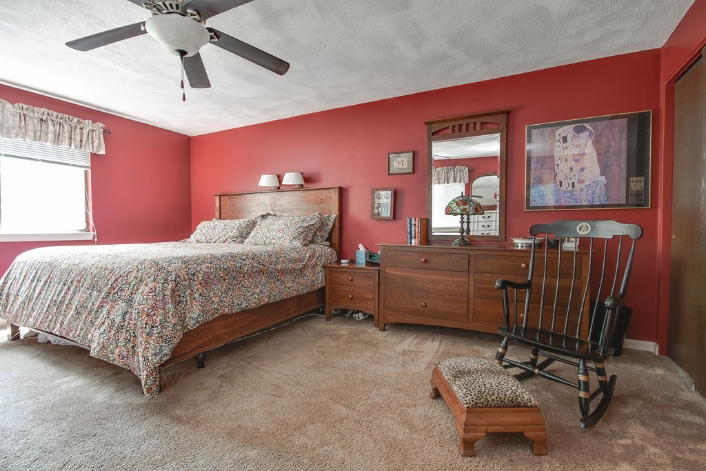124 Mountain Gate Road, Unit 124 Ashland, MA 01721 - Photo 14 of 19 a bedroom with a bed dresser and a window