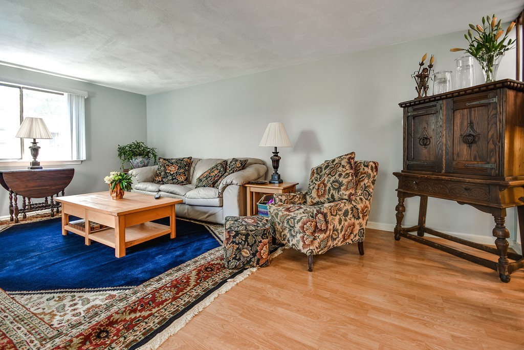 124 Mountain Gate Road, Unit 124 Ashland, MA 01721 - Photo 4 of 19 a living room with furniture and a wooden floor