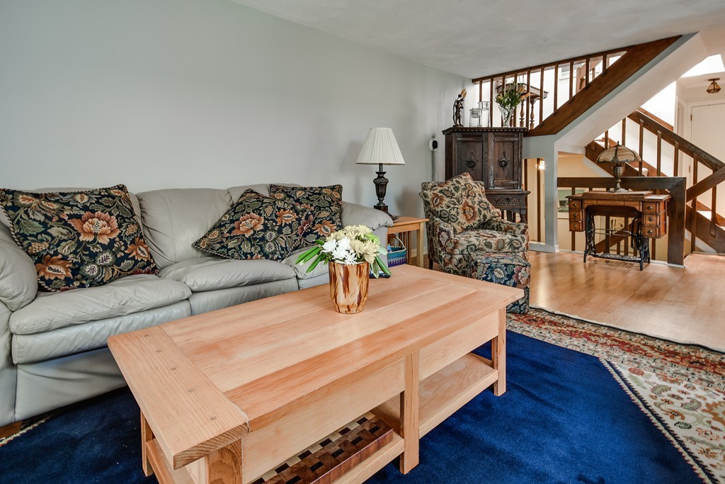 124 Mountain Gate Road, Unit 124 Ashland, MA 01721 - Photo 5 of 19 a living room with furniture and a wooden floor