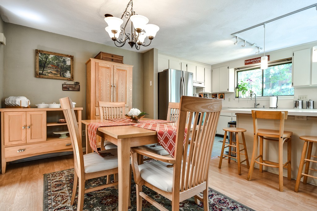 124 Mountain Gate Road, Unit 124 Ashland, MA 01721 - Photo 8 of 19 a view of a dining room with furniture window and outside view