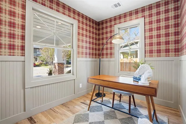 a living room with furniture and floor to ceiling windows