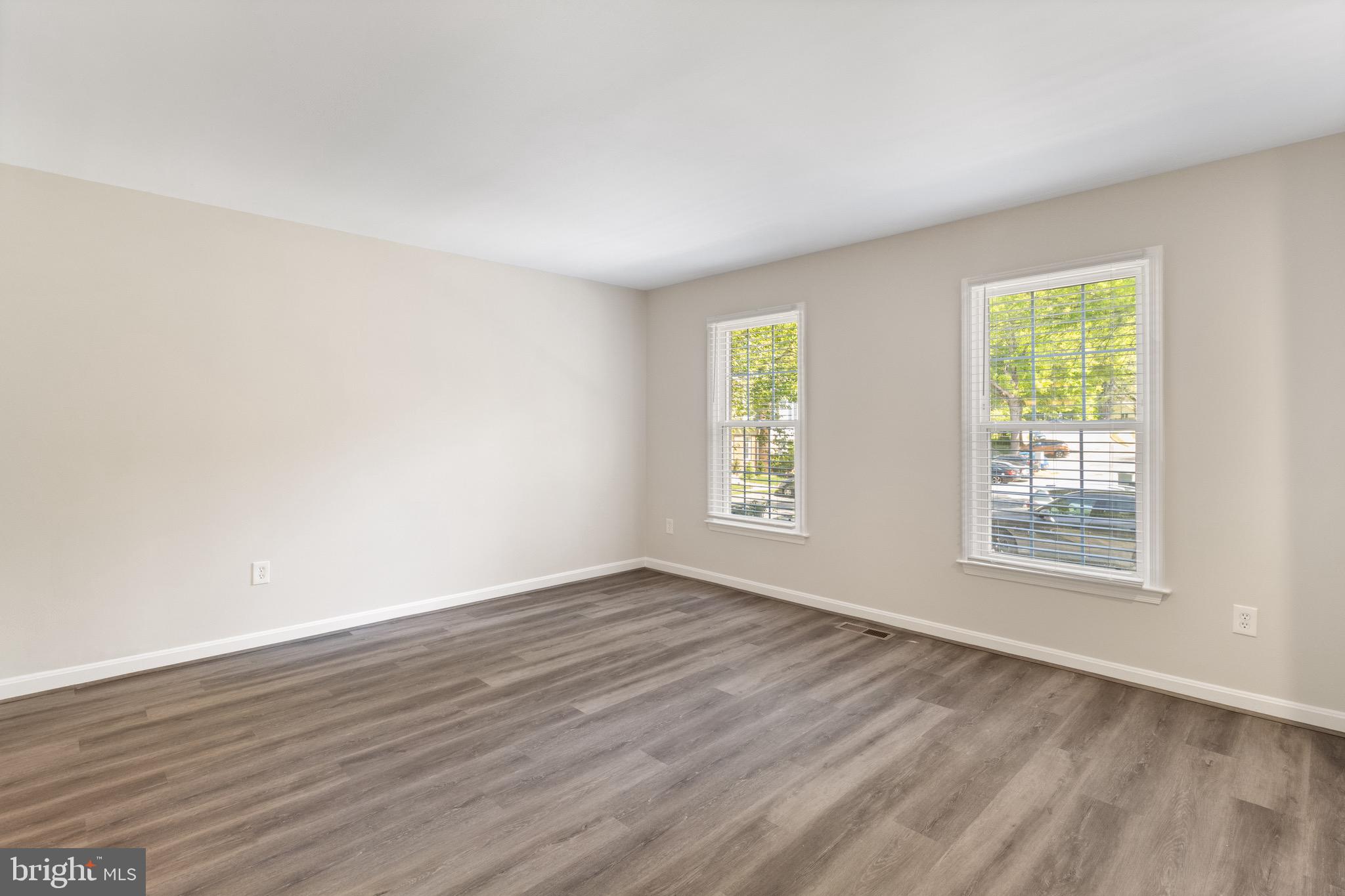 8581 Chester Grove Court Springfield, VA 22153 - Photo 5 of 38 an empty room with wooden floor and windows