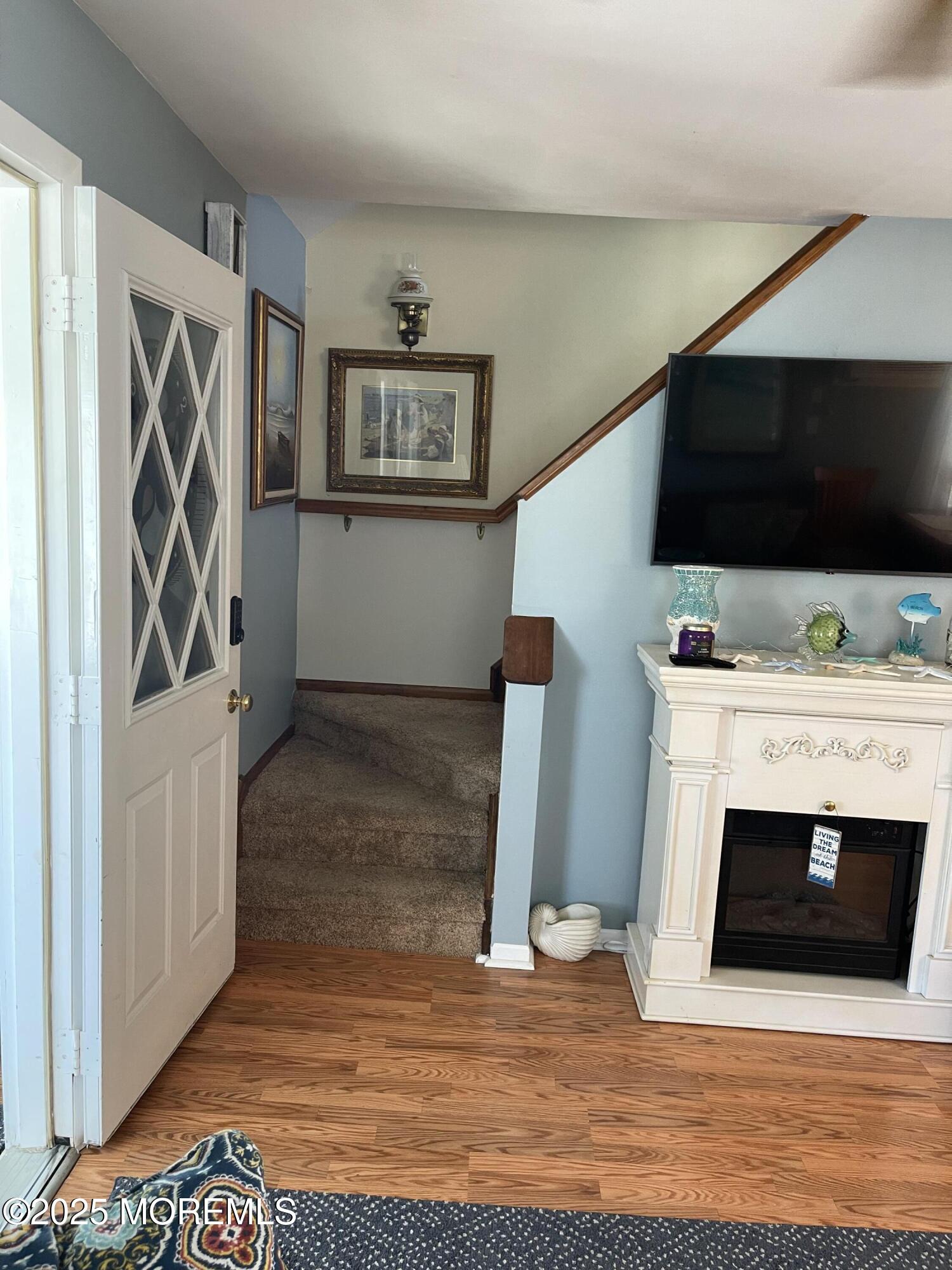 102 Brown Avenue Lavallette, NJ 08735 - Photo 14 of 22 a view of a livingroom with wooden floor and a fireplace