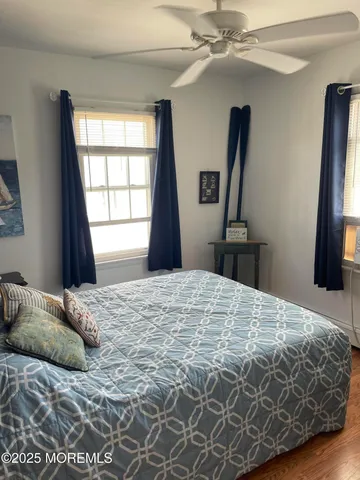 a bedroom with a bed and a flat tv screen on dresser