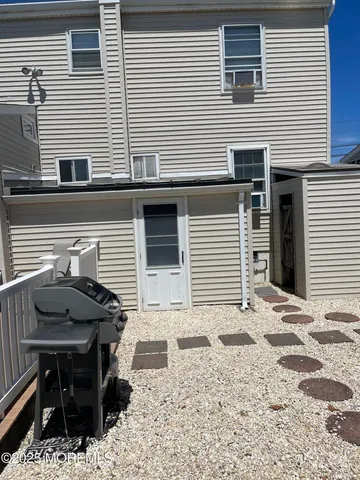 a view of a house with backyard porch and sitting area