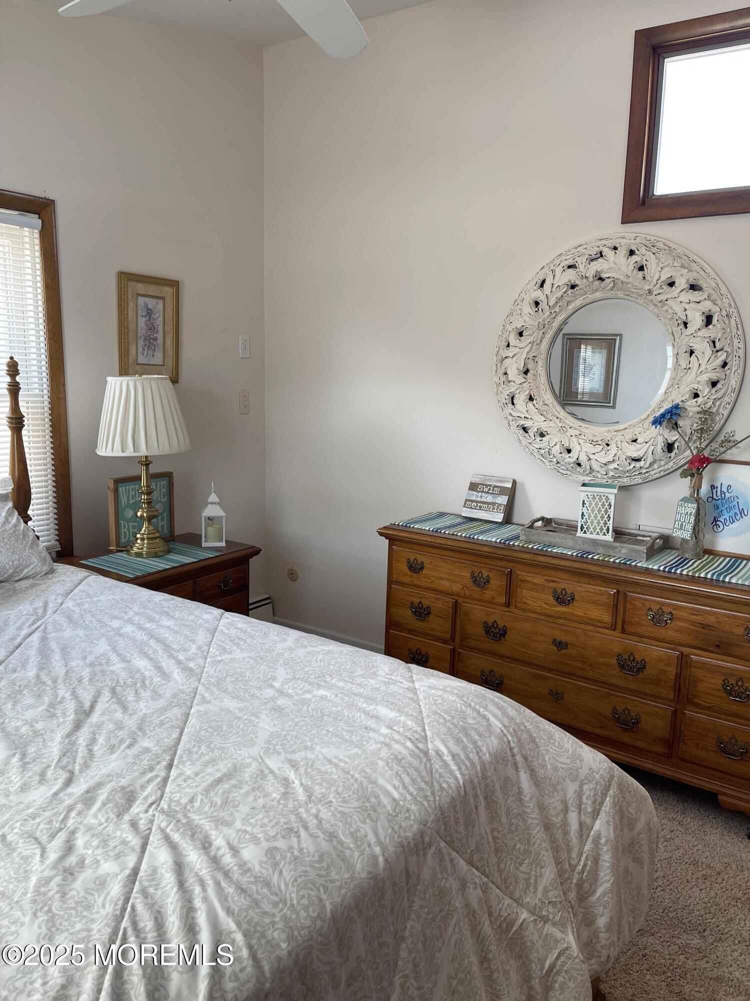 102 Brown Avenue Lavallette, NJ 08735 - Photo 6 of 22 a bedroom with a bed and a mirror on dresser