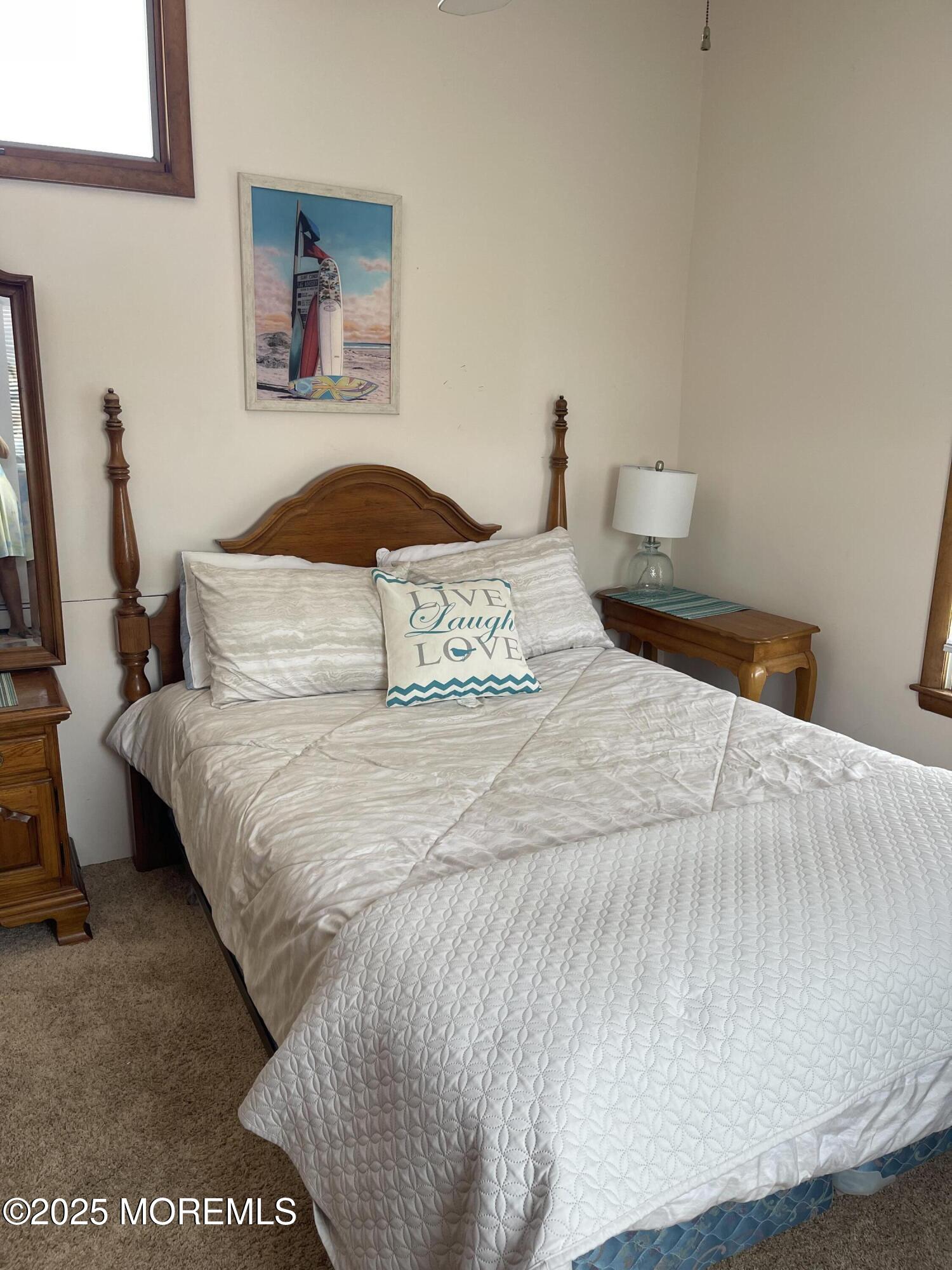 102 Brown Avenue Lavallette, NJ 08735 - Photo 8 of 22 a bedroom with a bed and a night stand