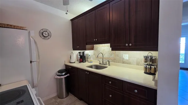 a kitchen with a sink and a refrigerator