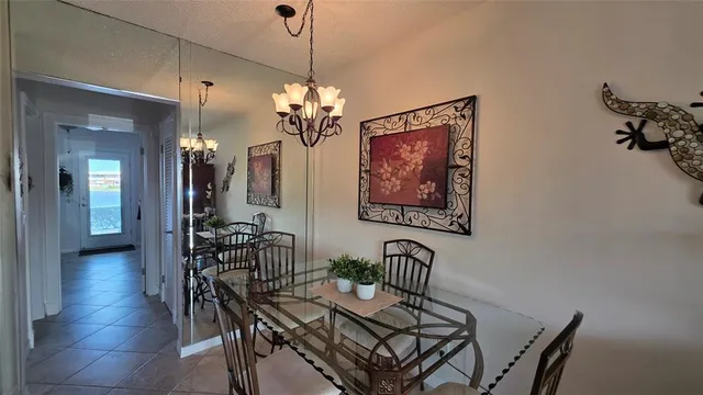 a view of a dining room with furniture and chandelier
