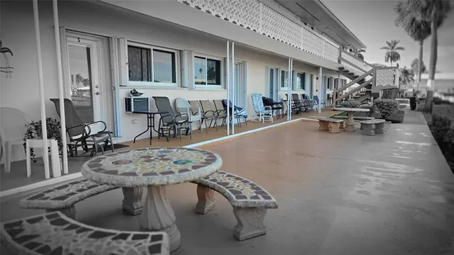 a dining room with furniture a mirror and wooden floor