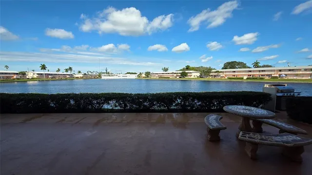 a view of a lake with a table and chairs