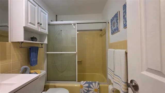 a bathroom with a shower and a sink