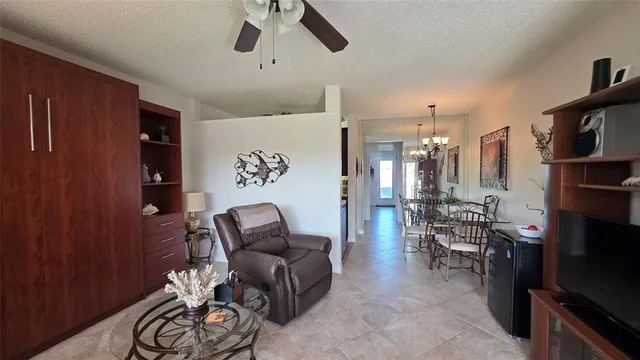 a living room with furniture a rug and a flat screen tv