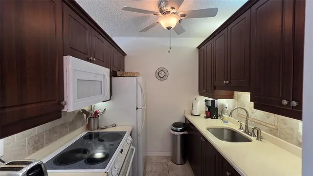 a kitchen with a sink and a refrigerator