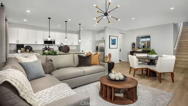 a kitchen with stainless steel appliances granite countertop a sink refrigerator and cabinets