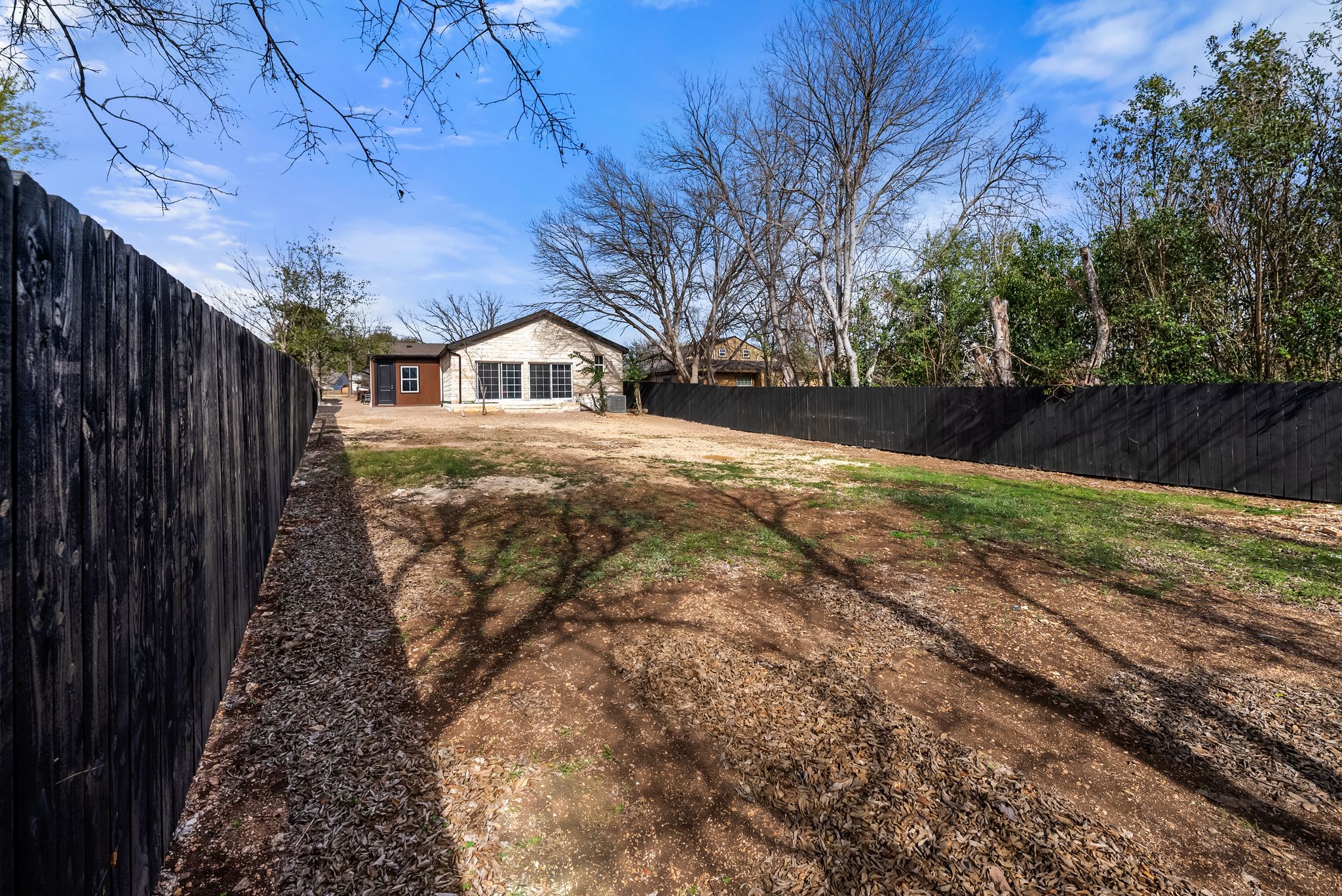 2201 Teri Road Austin, TX 78744 - Photo 25 of 37 a view of a yard in front of a house with large trees