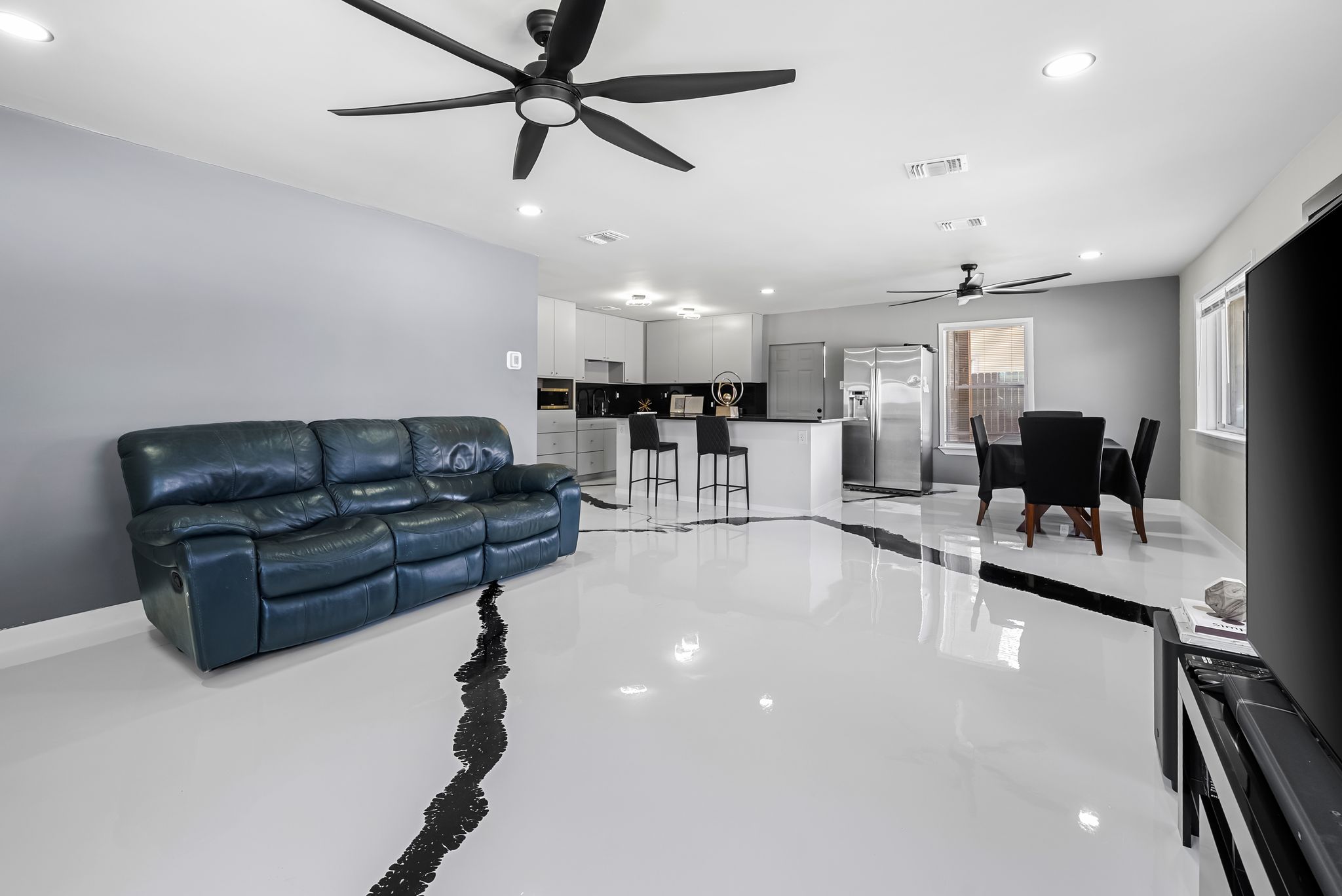 2201 Teri Road Austin, TX 78744 - Photo 5 of 37 a living room with furniture and a dining table with projector