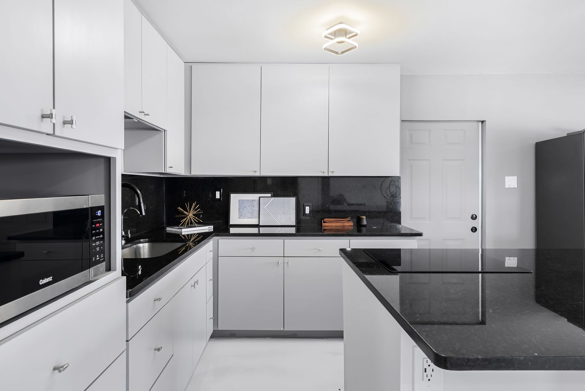 2201 Teri Road Austin, TX 78744 - Photo 7 of 37 a kitchen with cabinets appliances a sink and a counter space