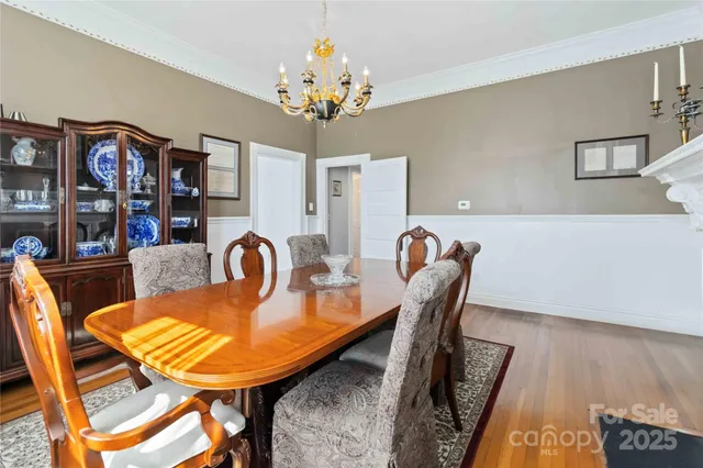 a dining room with furniture and chandelier