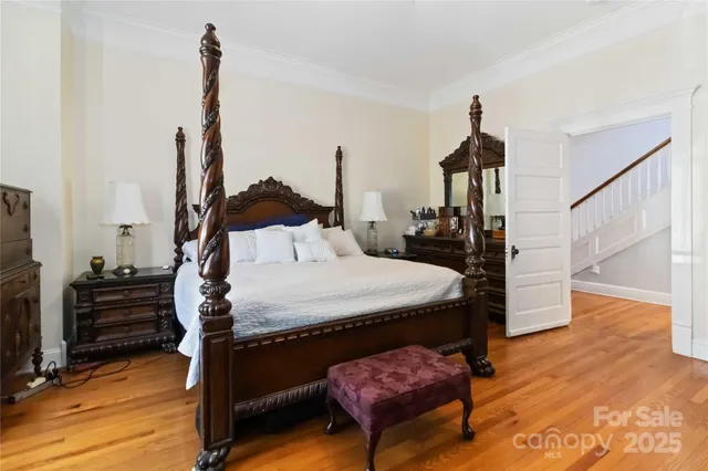 a bedroom with furniture and wooden floor