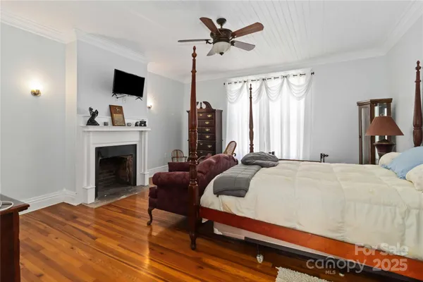 a bedroom with a bed and a fireplace