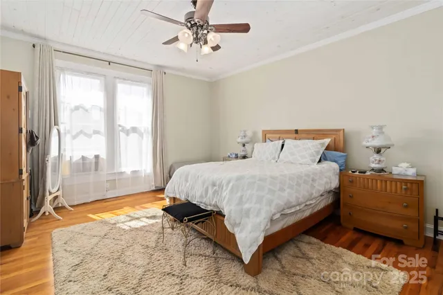 a spacious bedroom with a bed and a window