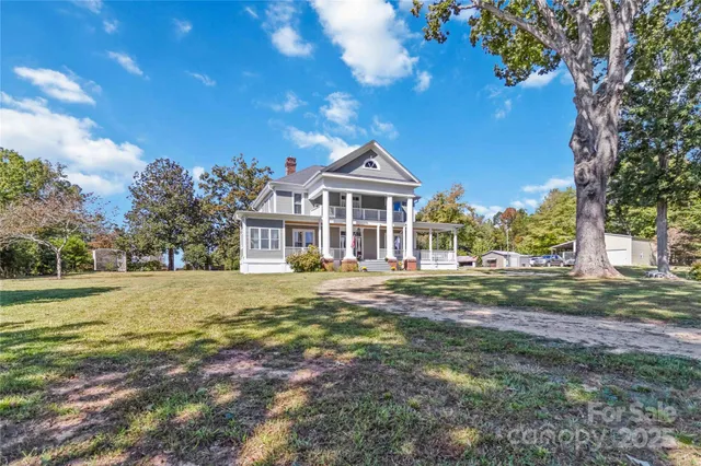 a front view of a house with a big yard