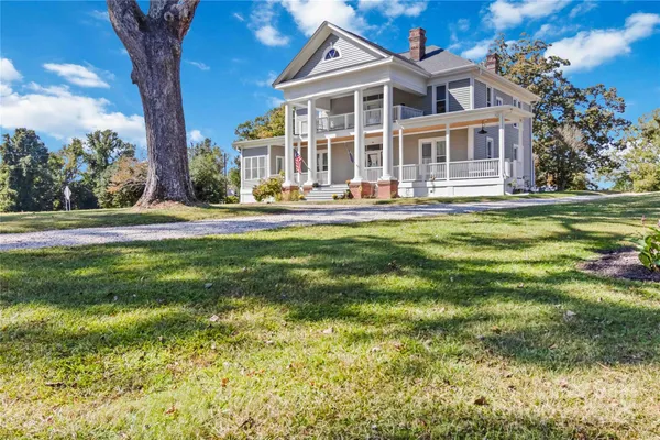 a front view of a house with a yard table and chairs