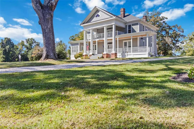 a front view of a house with a yard table and chairs