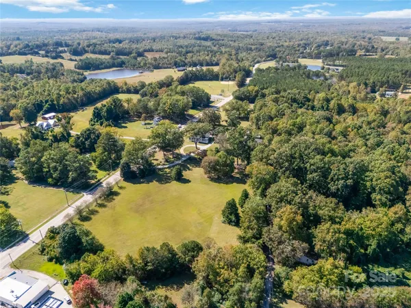 an aerial view of a houses with a yard
