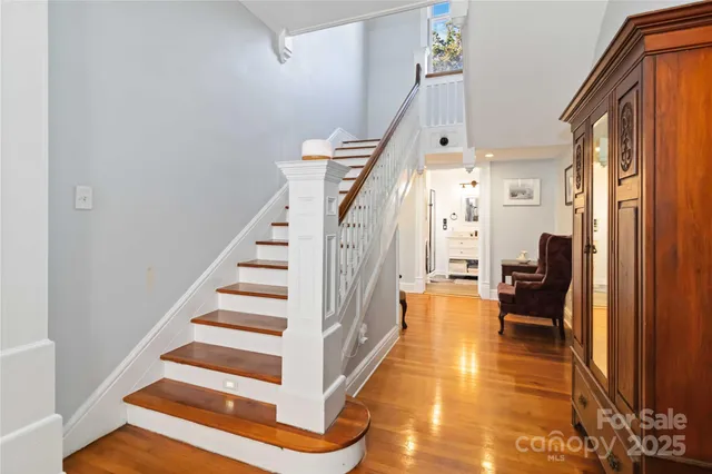 a view of entryway and hall with wooden floor