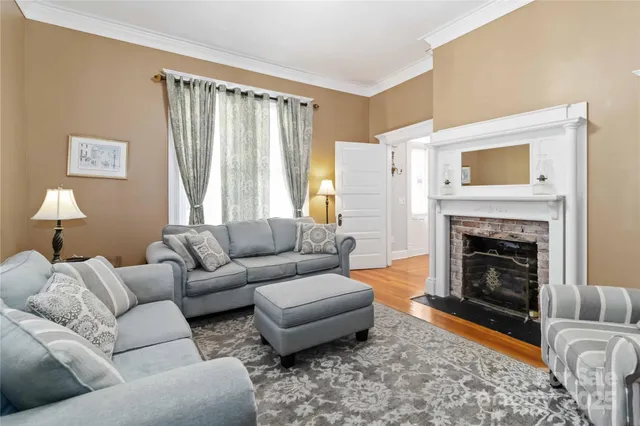 a living room with furniture and a fireplace