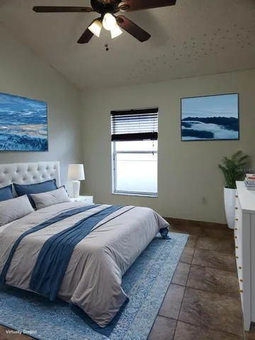 a bedroom with a large bed and a window