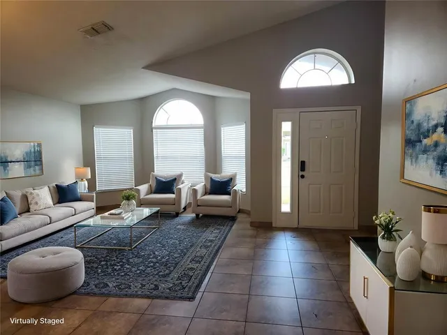 a living room with furniture and a large mirror