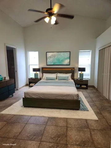 a bedroom with a bed and a mirror