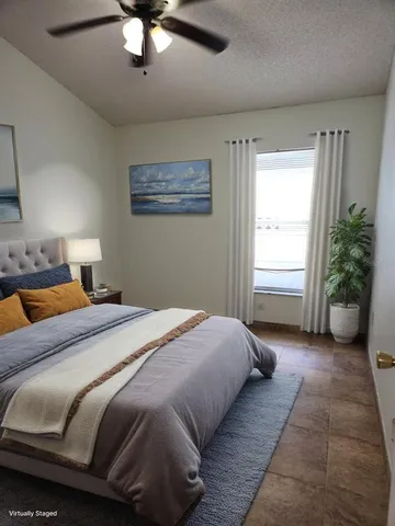 a bedroom with a bed and ceiling fan