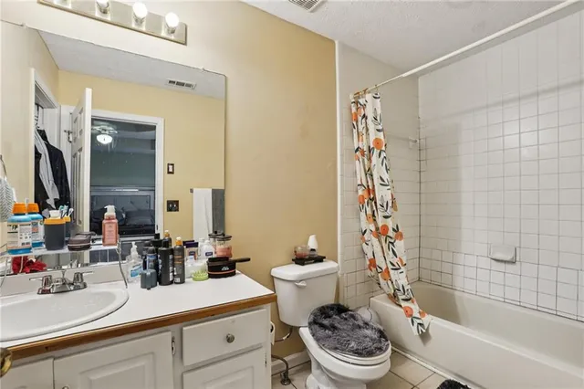a bathroom with a sink a toilet a mirror and shower